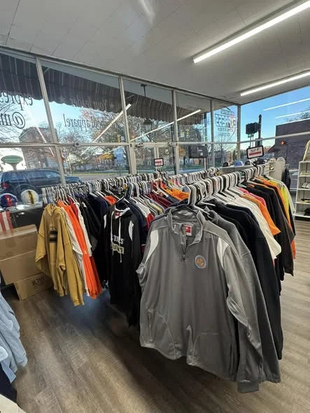 Finished custom apparel on the rack inside the Express Screen Printing shop