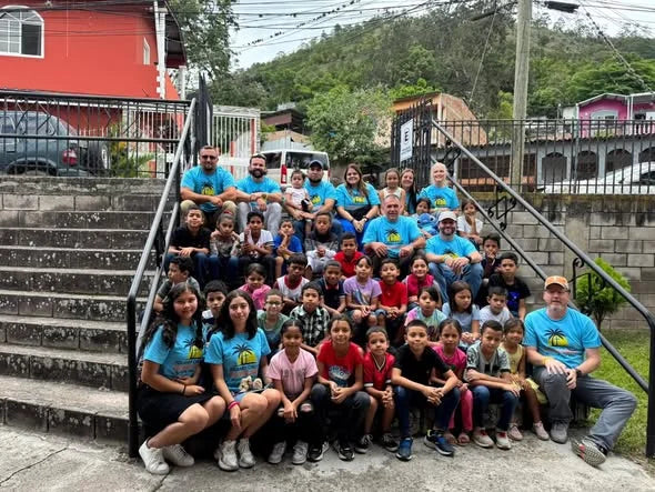 A community group in matching shirts at an event in Cleveland, Tennessee