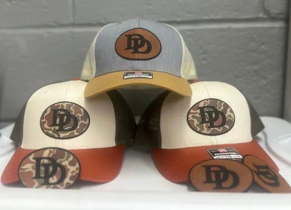 Embroidered caps carrying customer logos, stitched by Express Screen Printing in Cleveland, Tennessee